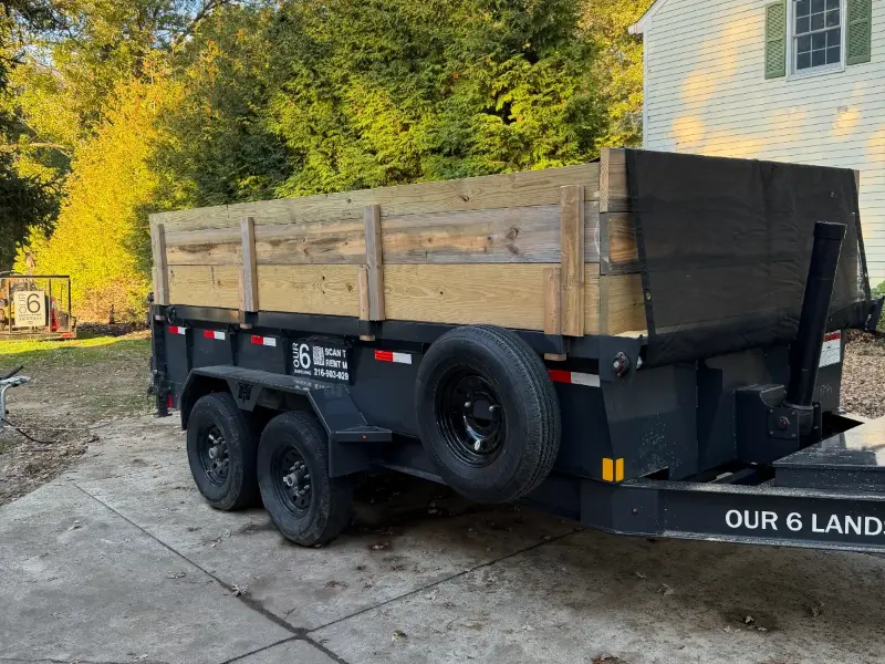 Our 6 dump trailer with wood side boards delivered to a driveway